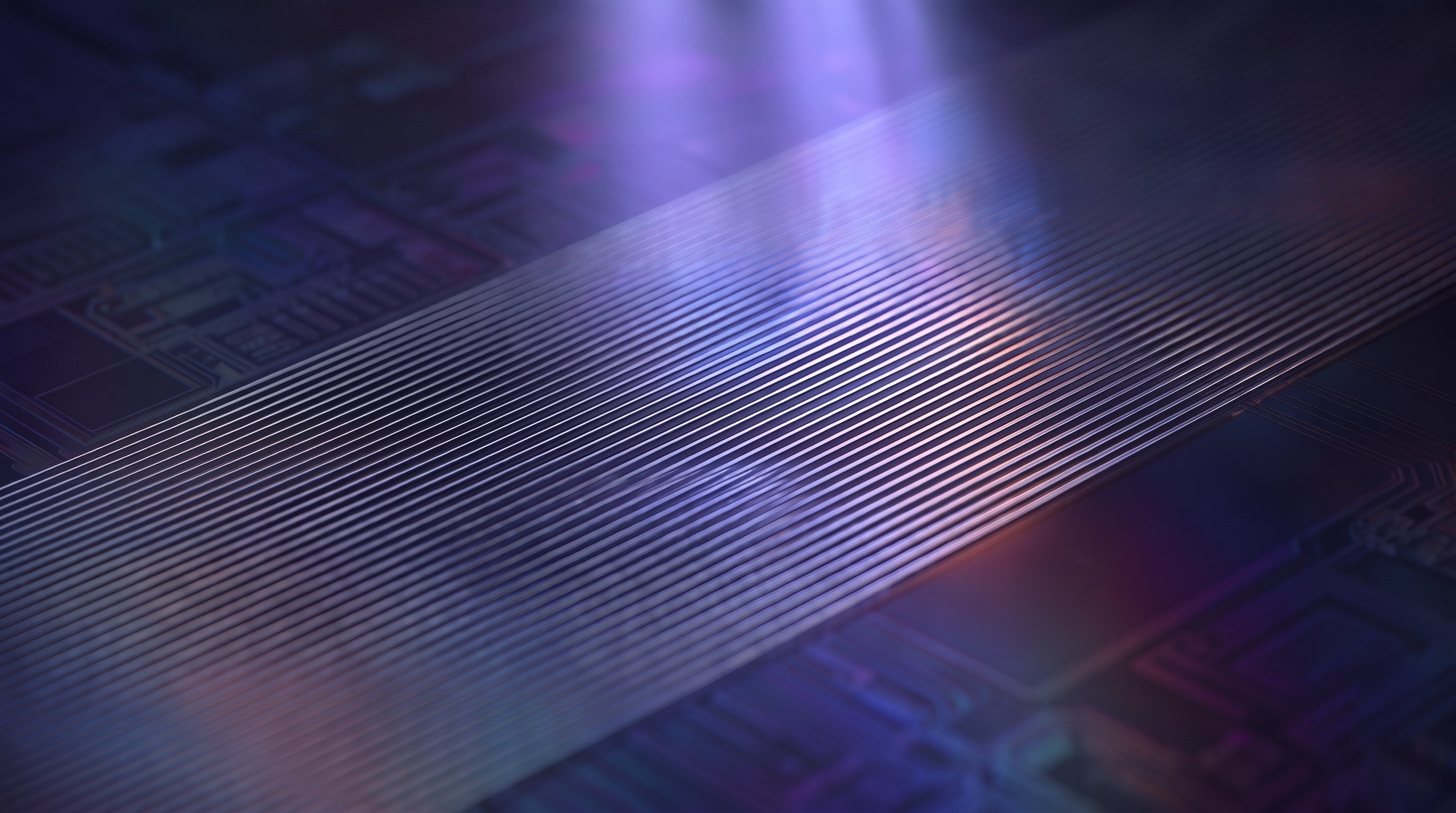 A broad band of extremely fine, straight silver-coloured metal lines runs diagonally across a silicon wafer, lit by a soft violet beam of light from above.